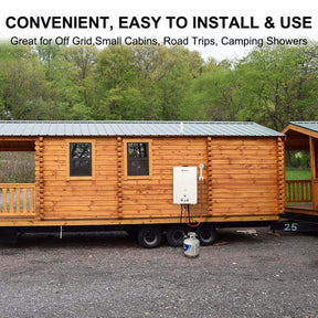 A small cabin with a trailer attached, featuring a camplux water heater.