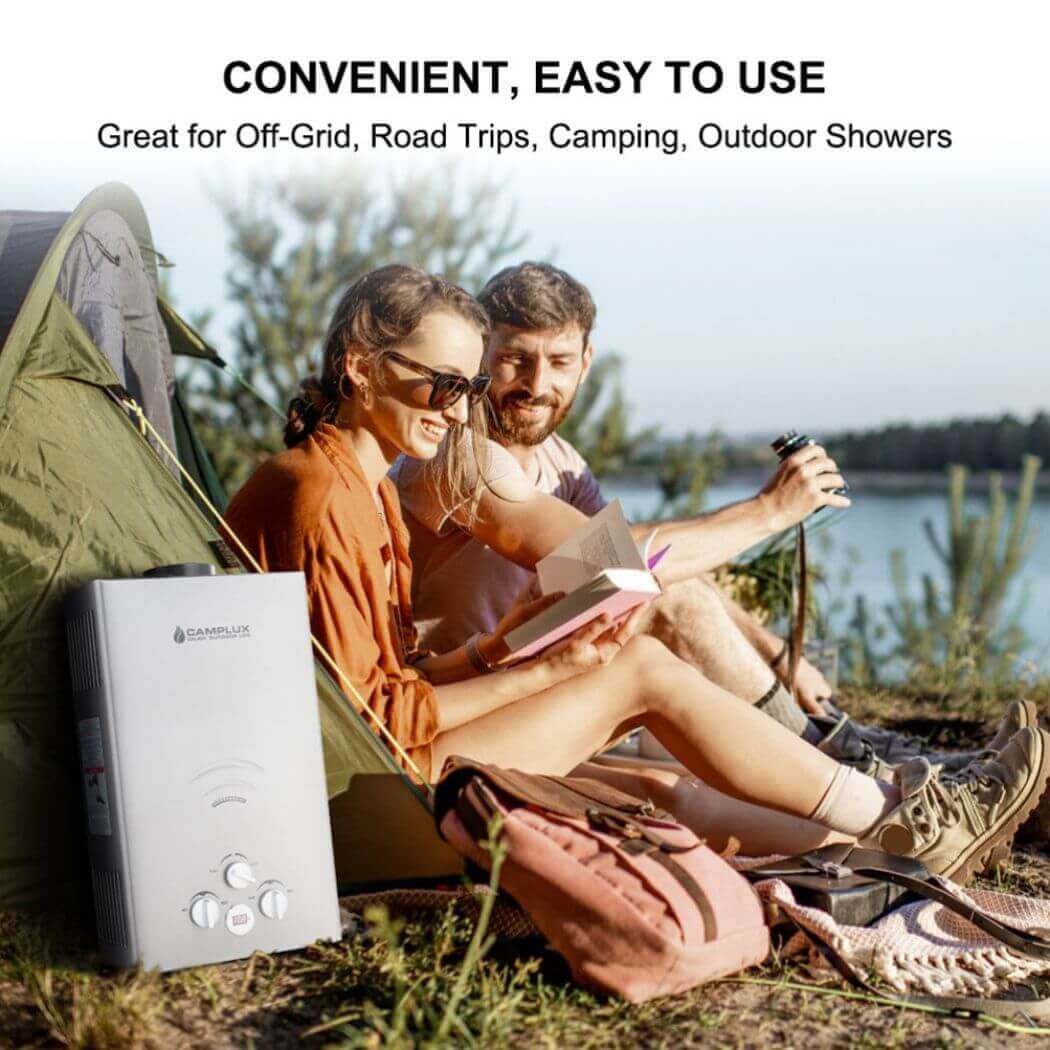 A couple sitting in a tent with a Camplux water heater beside them, enjoying their camping trip.