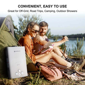 A couple sitting in a tent with a Camplux water heater beside them, enjoying their camping trip.