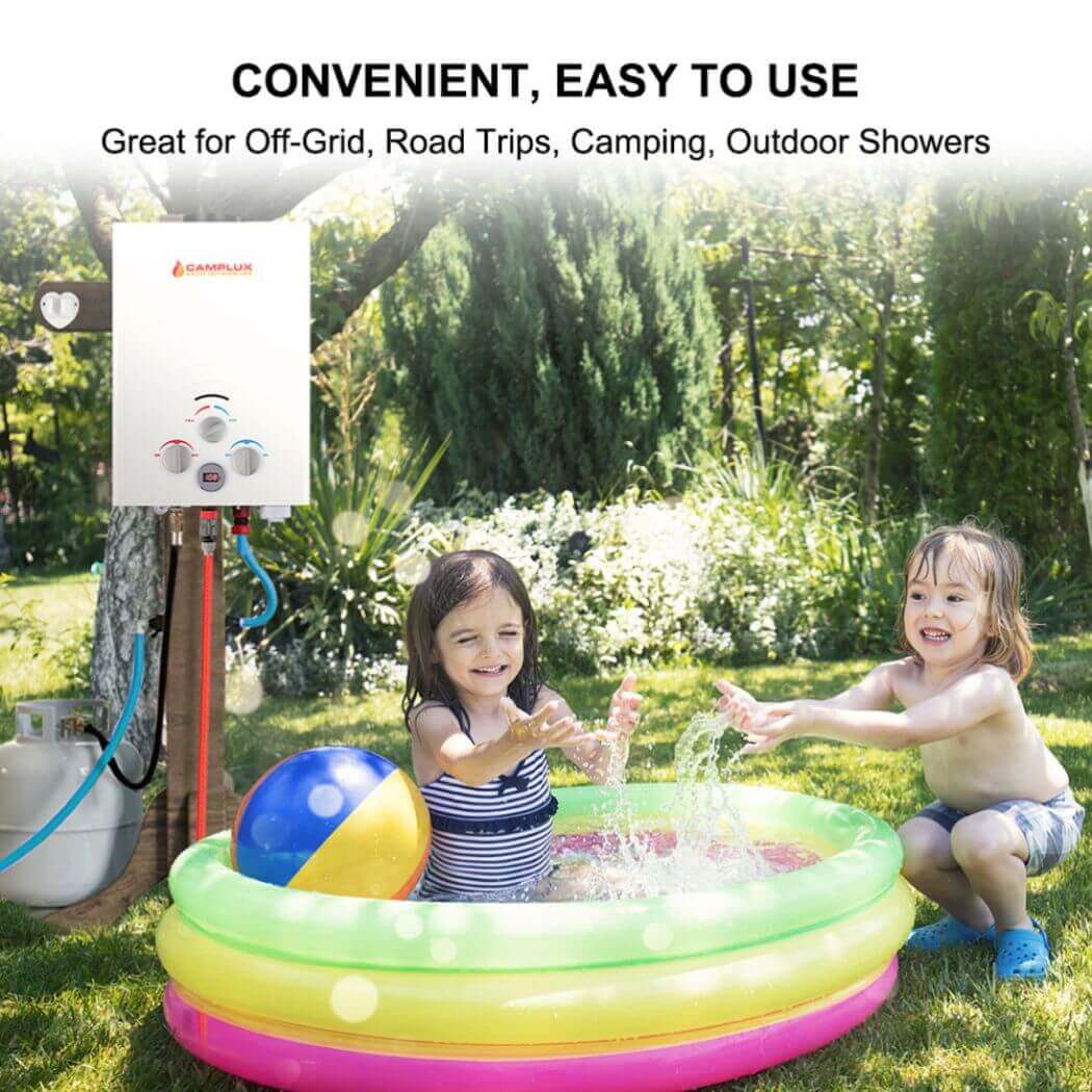 Two kids joyfully playing in an inflatable pool, splashing warm water from Camplux portable water heater.