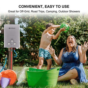 A woman and child joyfully playing in the grass near a Camplux water heater.