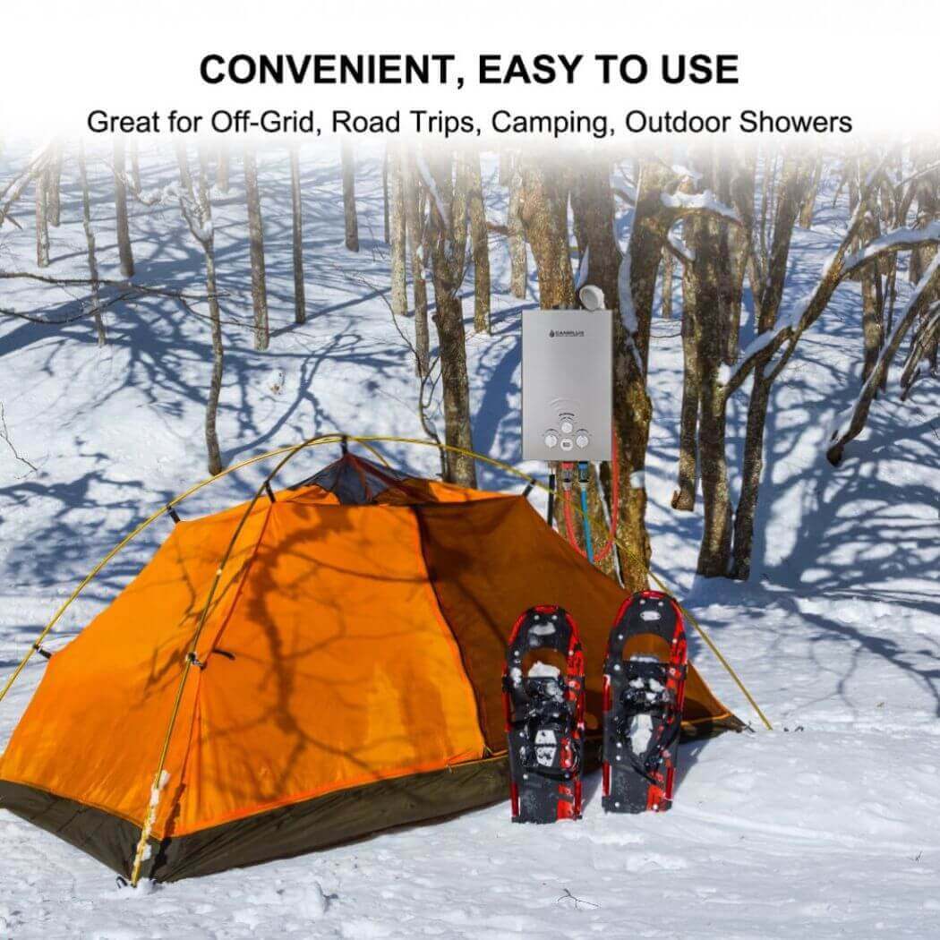 A tent and snowshoes in the snow, featuring the convenient and easy-to-use Camplux outdoor water heater hanging on a tree.