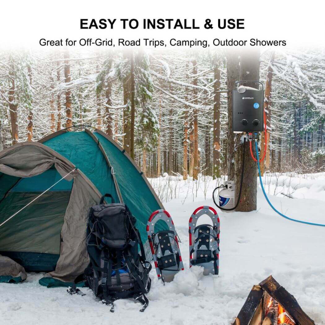A tent in snowy ground with a Camplux AY123B water heater connected, hanging on a tree.